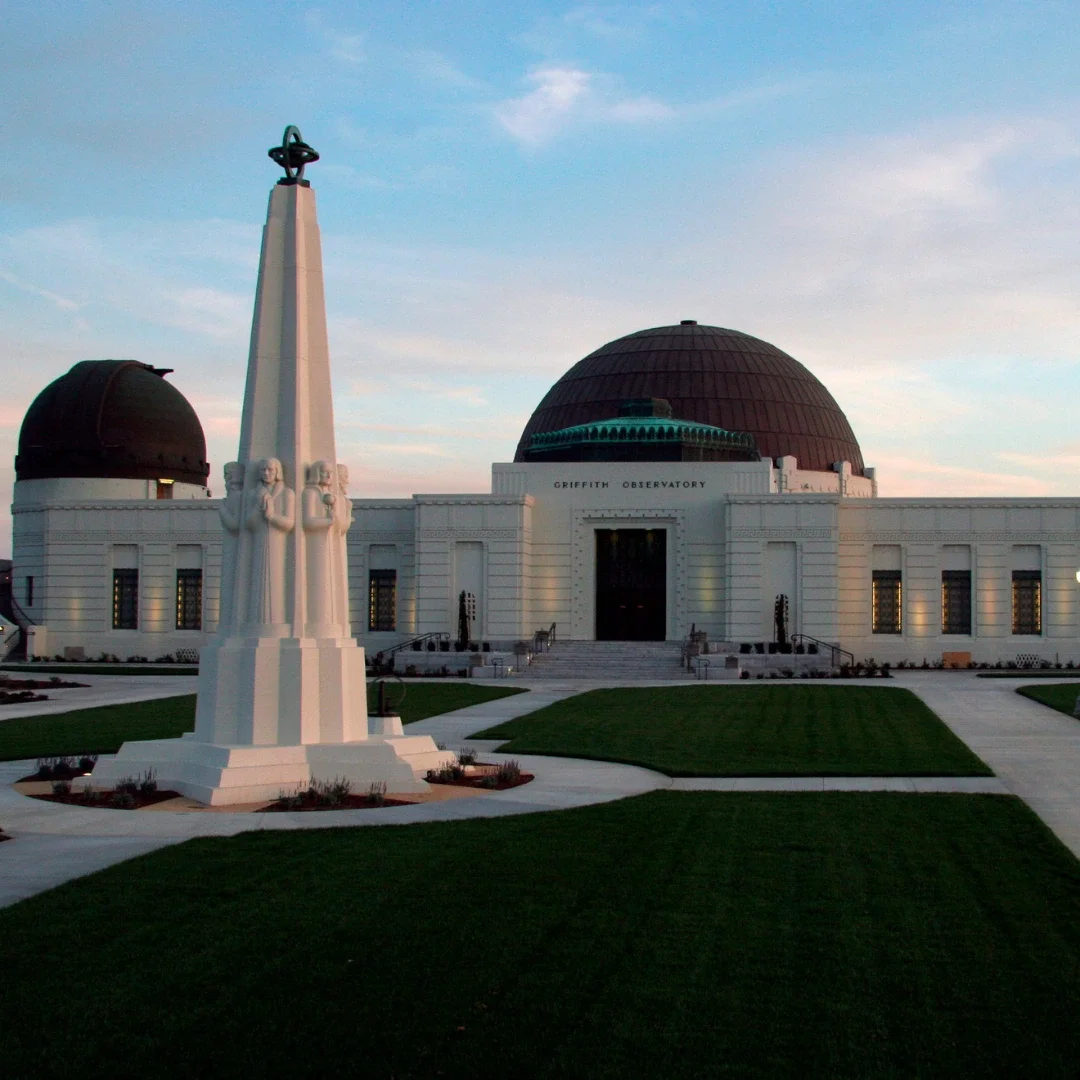 Griffith Observatory front entrance shown with the sunset behind it