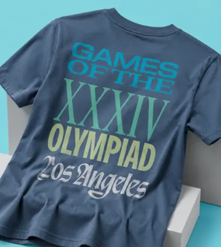 Tshirt with the words "Games of the XXXIV Olympiad Los Angeles" on the back in blue/green gradient font