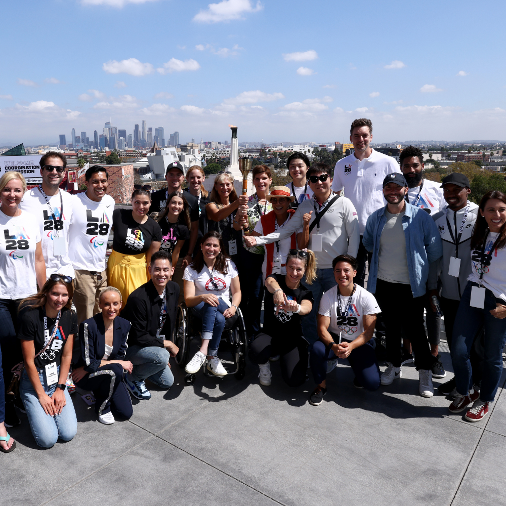 Group photo featuring more than a dozen Olympians and Paralympians smiling