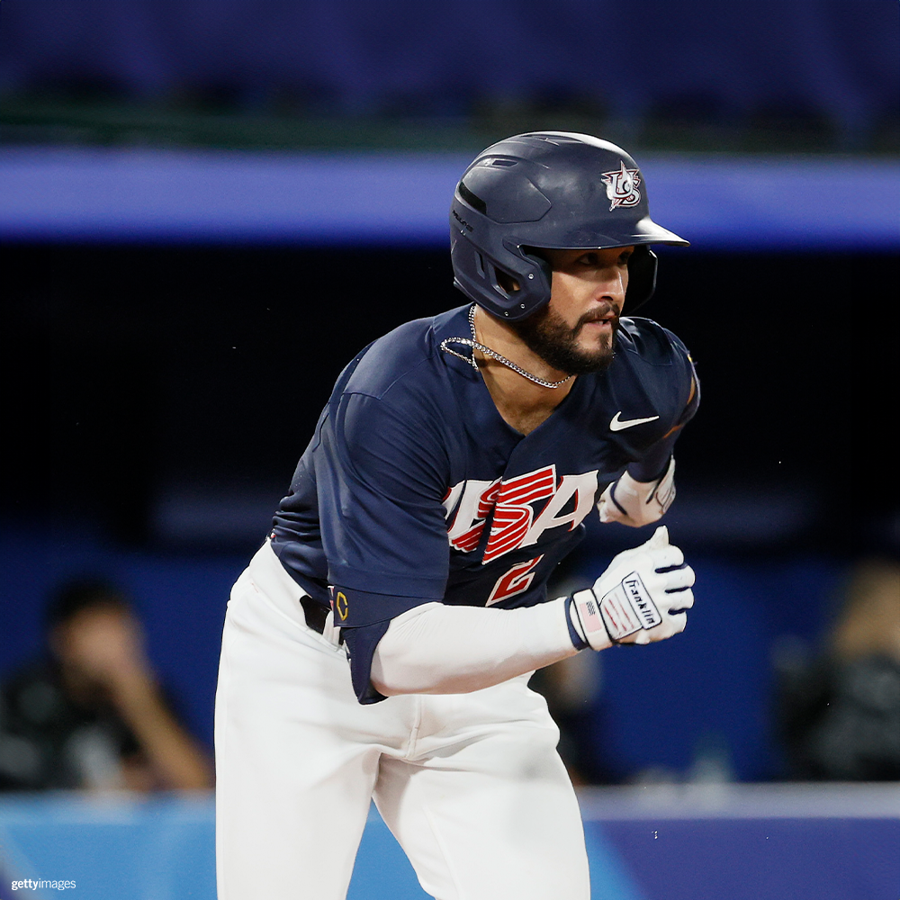 Baseball player running to a bsae