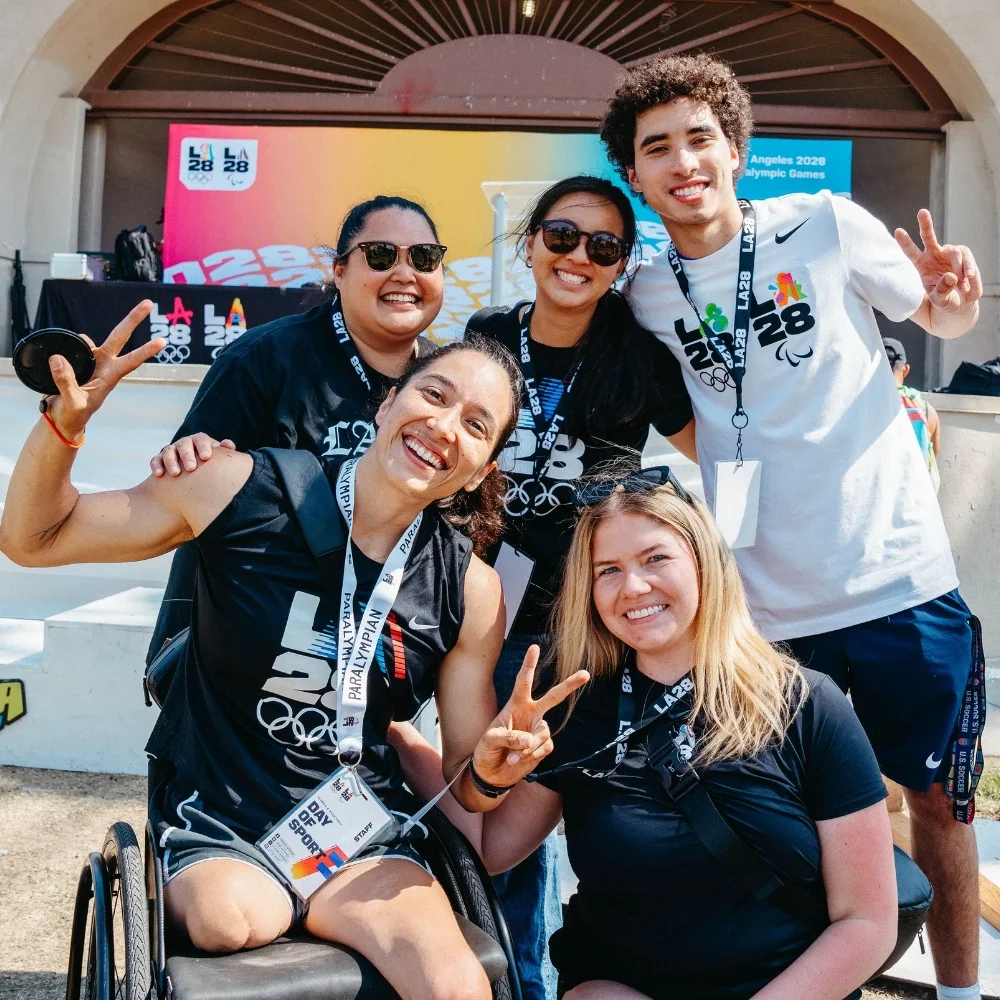Photograph of Natalia Mayara surrounded by other members of the LA28 Digital Engagement and Marketing team