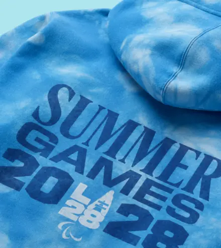 Bluebell tie dye hoodie with the words "Summer Games 2028 and the LA28 Paralympic Emblem