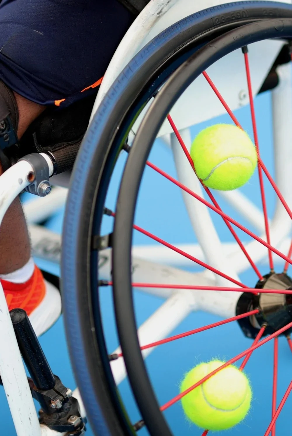 Handcyclist pedaling in front of the Arc de Triomphe at the Paris 2024 Summer Games