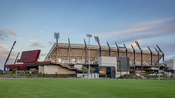 San Diego Stadium in the foreground with green grass flanking the side of the stadium. 