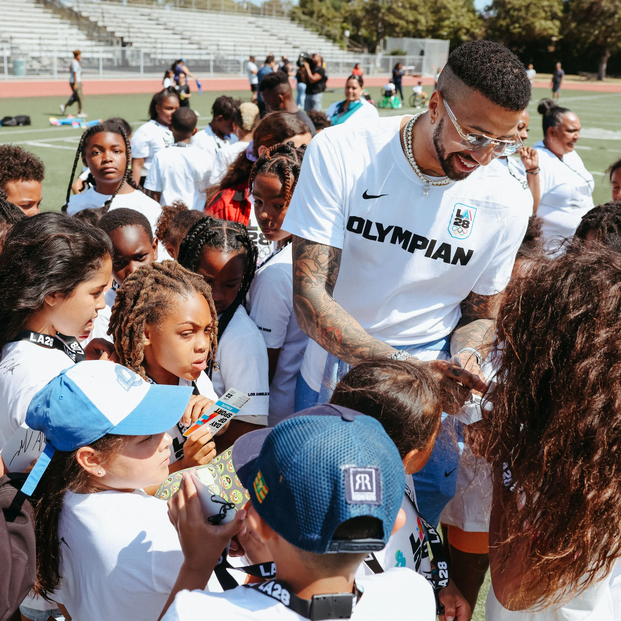 Fencing Olympian Miles Chamley-Watson signing autographs at LA28 Day of Sport