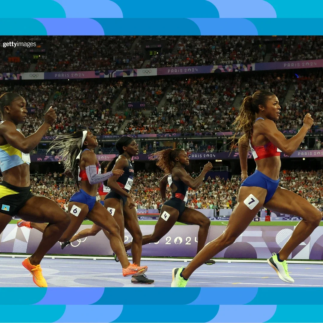 Photograph of track and field athletes sprinting on a track