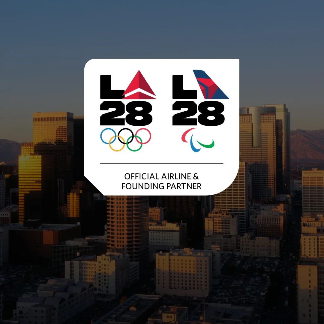 City scape background of Los Angeles with the Delta emblem badge for the LA28 Olympic and Paralympic games