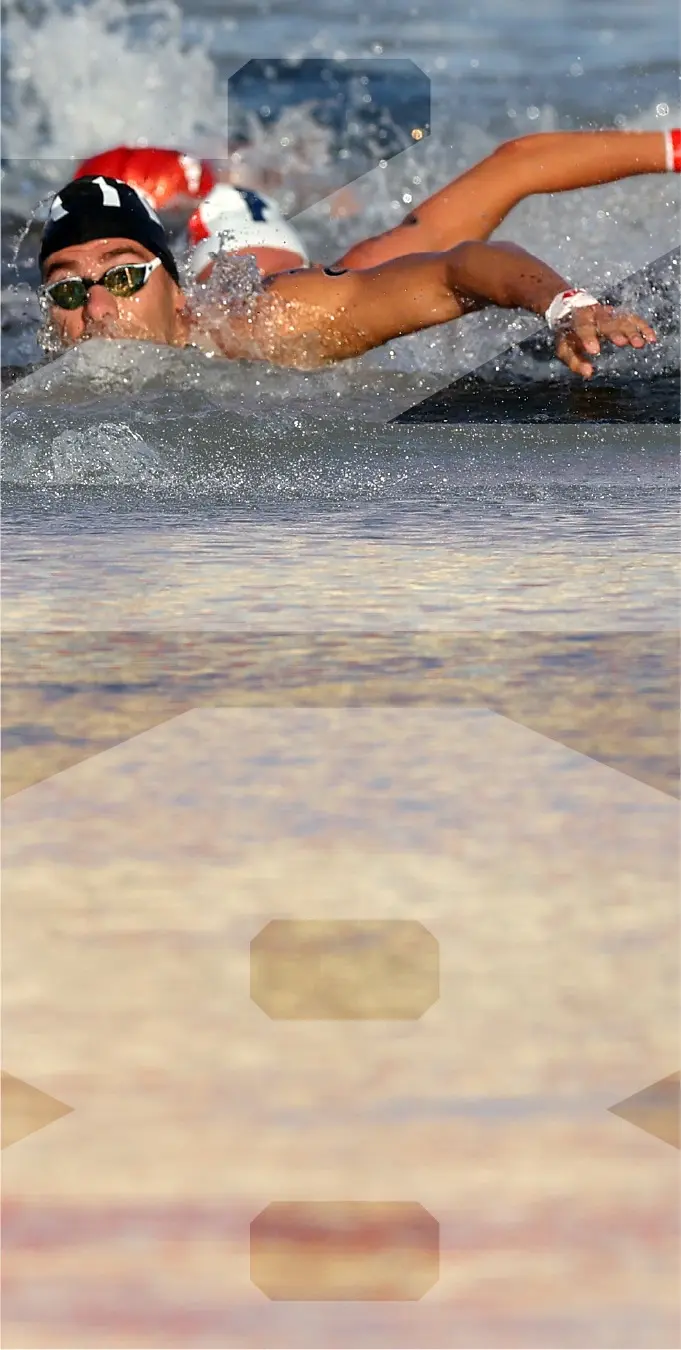 Photograph of a female surfer in a pink rashguard dropping in on a wave with the number 28 overlayed on top of the image