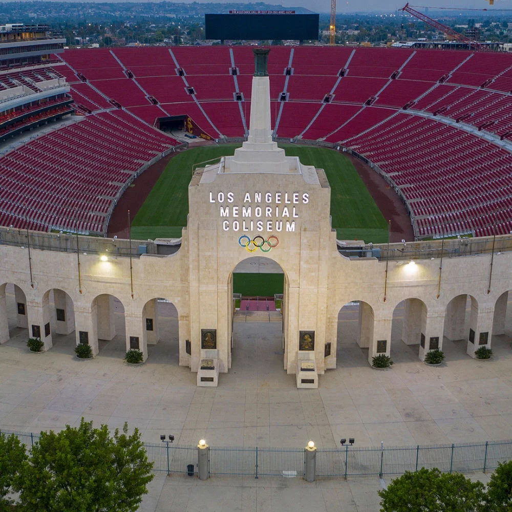 photo of the LA Memorial Coliseum entrance gate with the seating and stands viewable in the background