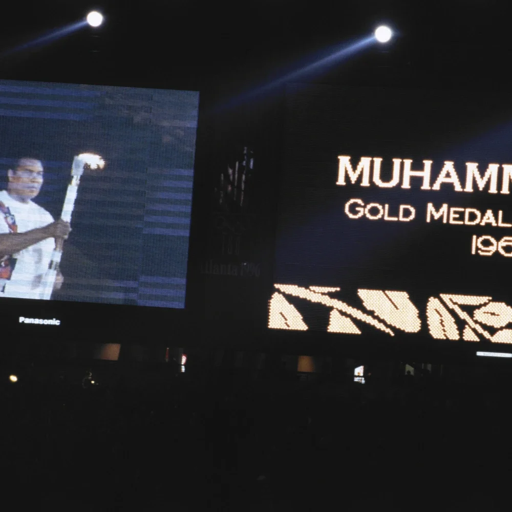 An image of Olympian and heavyweight boxing champion Muhammad Ali lighting the Olympic cauldron at the 1996 Games in Atlanta.