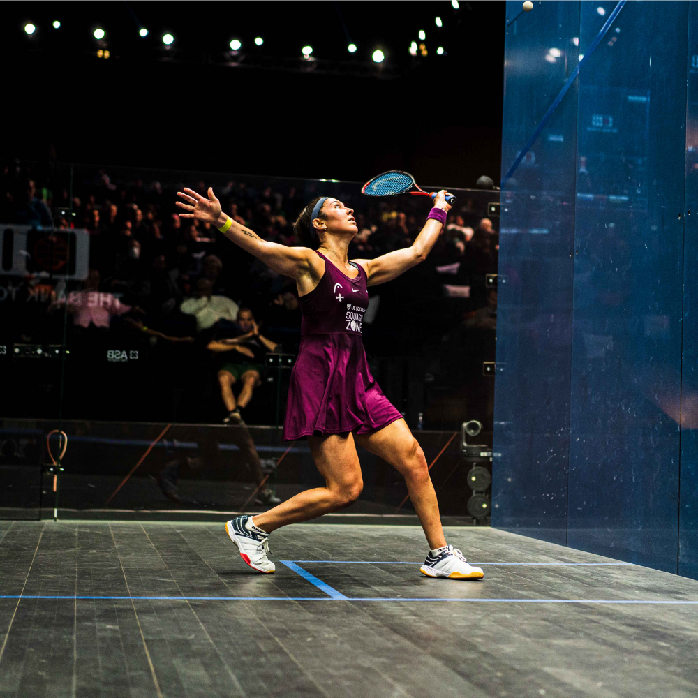 A squash player on the court holding a racket