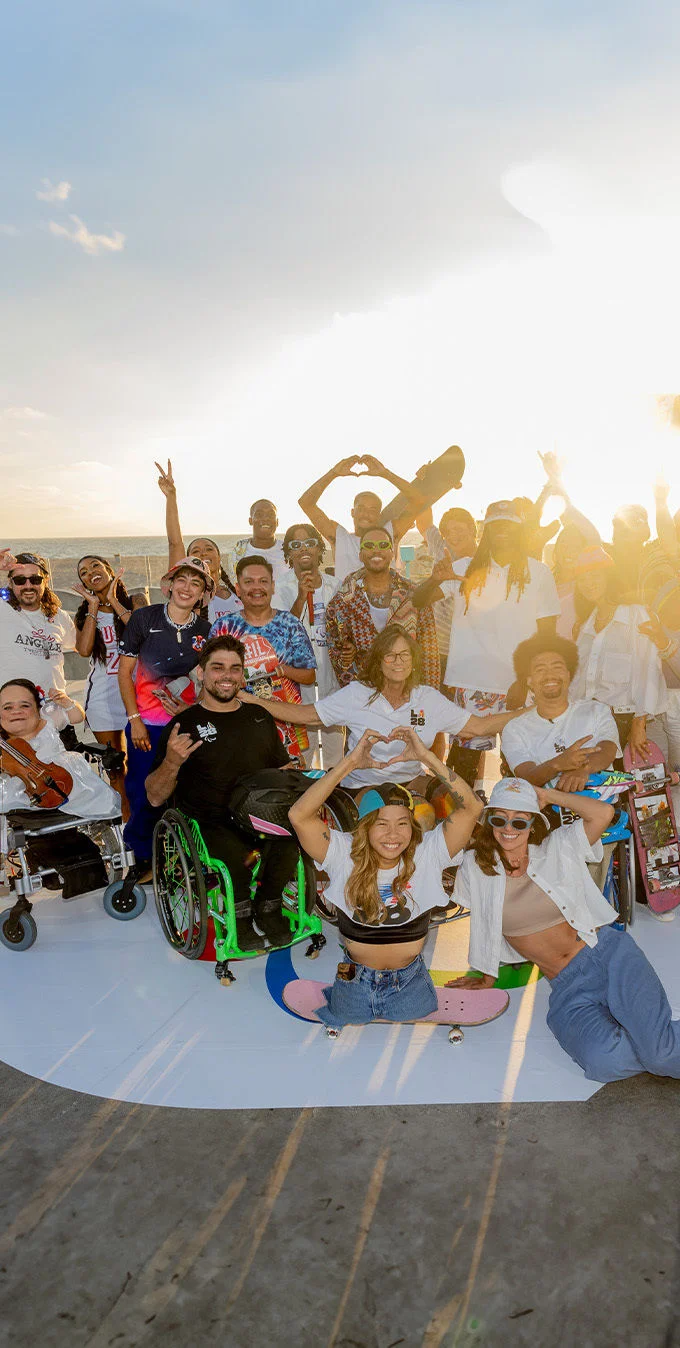 Photograph of a group of adaptive skaters, adaptive performers and Anderson .Paak at Venice Beach, CA for the LA28 Paralympic Handover Celebration 