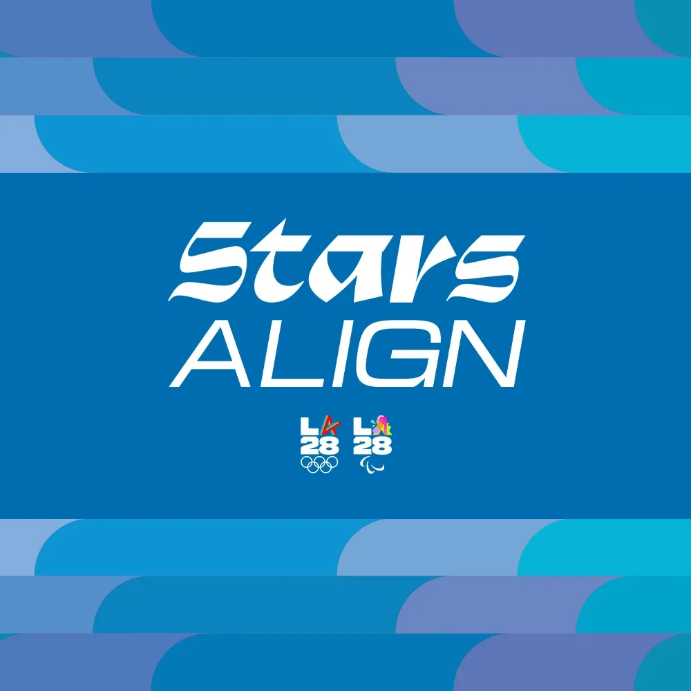 Stars Align text on top of the LA28 Bluebell background with the LA28 dual emblems