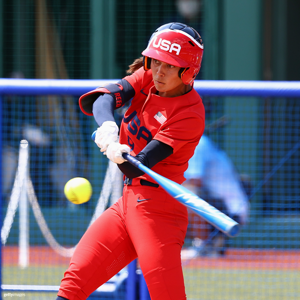 Female softball player swinging the bat