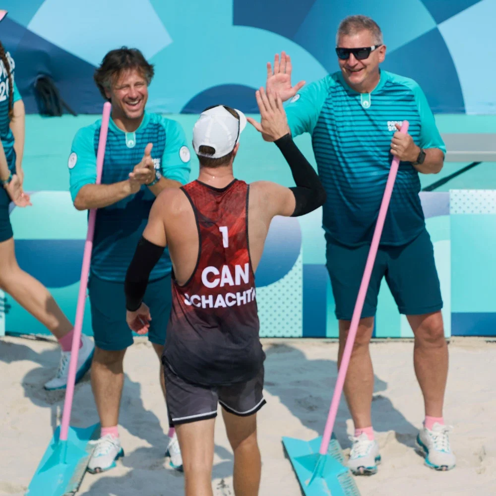 A photo of Volunteers smiling and giving a high five 