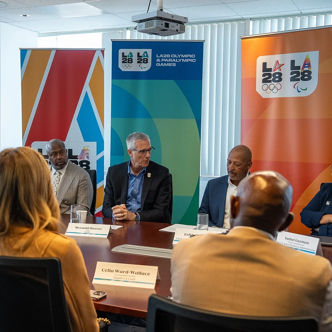 Group of community leaders and LA28 staff members including LA28 CEO Reynold Hoover meeting together at a conference table to discuss the LA28 Procurement Plan