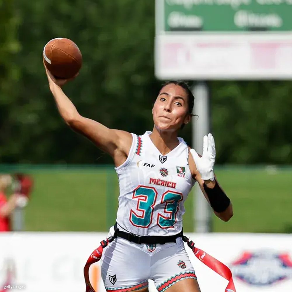 Female flag football player throwing a pass